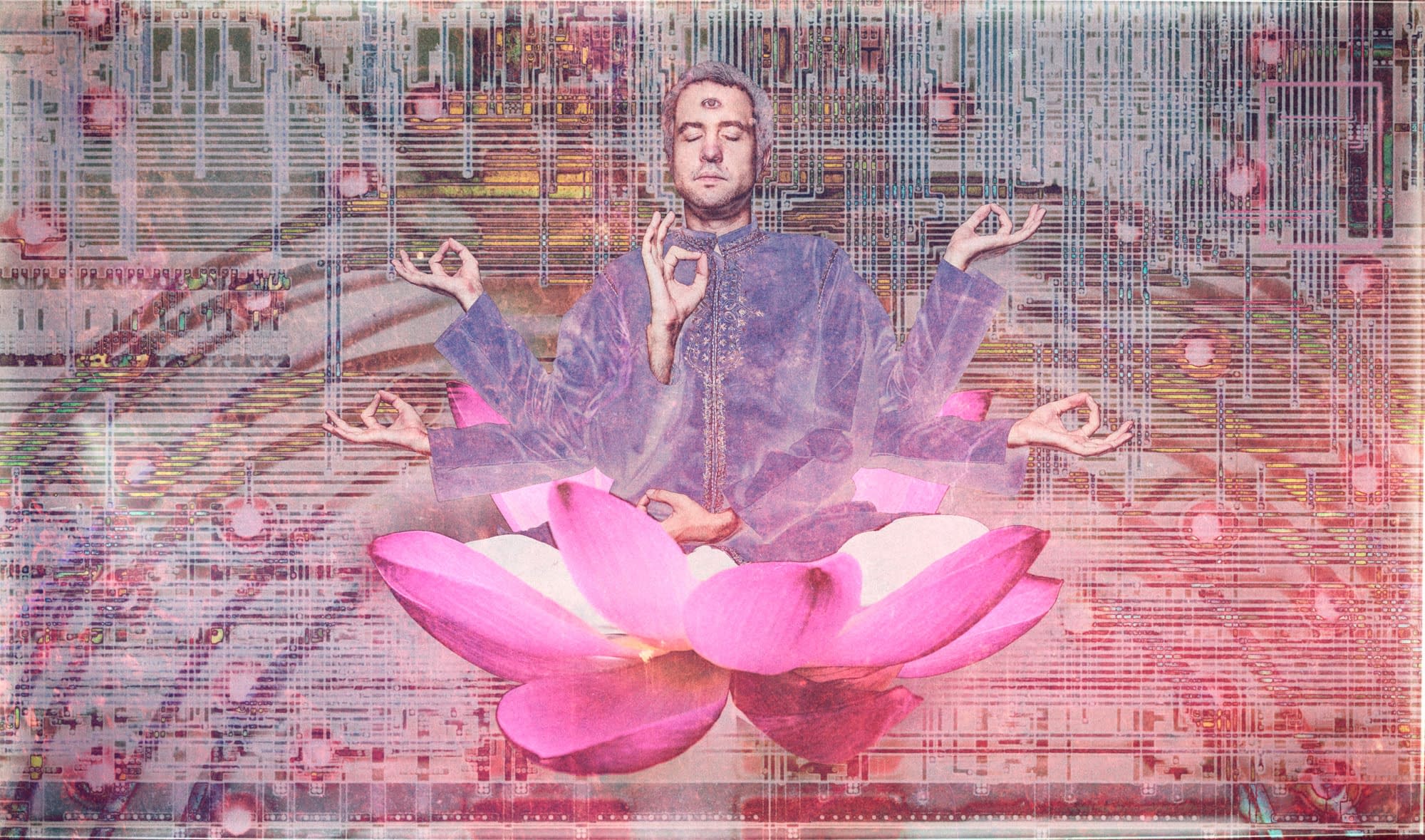 This image depicts a man in a pink robe, meditating in the lotus position. He is wearing a purple shirt and has his eyes closed as he makes a hand gesture with one of his hands. The background is filled with an abstract pattern of pinks and greys, creating an ethereal atmosphere around him. His other hand rests on his lap, completing the pose.